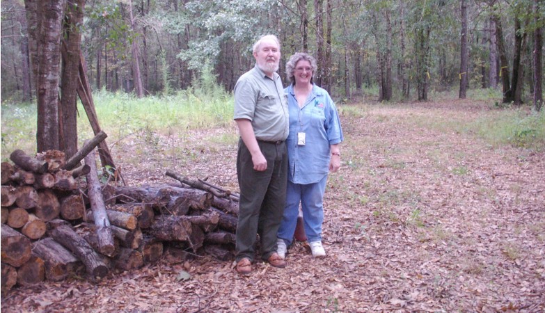Ann and I stand by the firewood.